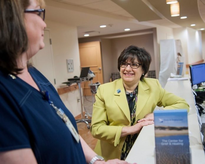 GOOD CARE: Home & Hospice Care of Rhode Island CEO Diana Franchitto, right, speaks with nurses at the facility’s second-floor nurses station. The organization is the second-oldest of its kind in the U.S. / PBN PHOTO/MICHAEL SALERNO