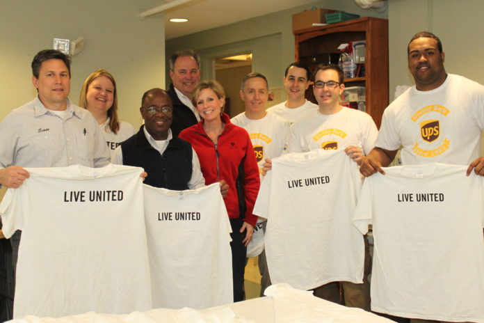 VOLUNTEERS FROM UPS and United Way of Rhode Island gather after helping organize a sewing room used by House of Hope Community Development Corporation for their supported employment program, House of Hope Boutique. / COURTESY UNITED WAY