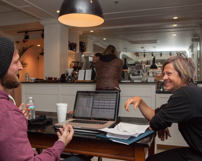PLACE TO BE: Members of the San Diego-based band Switchfoot chose The Dean for lodging when they were in Providence for a show in March. Above, audio technician Travis Bing, left, speaks with bassist Tim Foreman. / PBN PHOTO/TRACY JENKINS