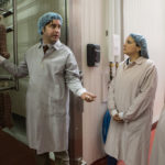 FOOD FOR THOUGHT: Daniele Inc. co-owner Davide Dukcevich gives a tour of the facility to Providence-Warwick Convention & Visitors Bureau Vice President of Marketing and Communication Kristen Adamo, left, and President Martha Sheridan. The bureau is looking to find ways to partner around the idea of enhancing the state&rsquo;s &ldquo;foodie&rdquo; reputation. / PBN PHOTO/RUPERT WHITELEY