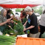 LINDA KUSHNER, left, sells produce at the Hope Street Farmers Market. On Thursday, the R.I. Department of Environmental Management announced the agency had awarded $210,000 in grants to support 17 different projects geared toward helping farmers and local seafood businesses promote and market their Rhode Island-grown products. / COURTESY HOPE STREET FARMERS MARKET