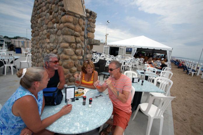 A BANKRATE.COM RANKING of the 50 states according to their appeal for retirees placed Rhode Island at No. 29, up from No. 40 last year. Above, from left to right, Lisa and Paul Leonowicz and Laurie and Chuck DiMauro enjoy lunch at Andrea in Westerly. / PBN FILE PHOTO/BRIAN MCDONALD