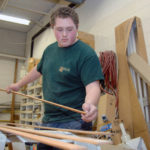 PUTTING IN WORK: Mitchell Folco, a student at New England Laborers&rsquo;/Cranston Public Schools Construction and Career Academy, works at Jutras Woodworking in Smithfield. / PBN PHOTO/BRIAN MCDONALD