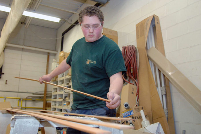 PUTTING IN WORK: Mitchell Folco, a student at New England Laborers’/Cranston Public Schools Construction and Career Academy, works at Jutras Woodworking in Smithfield. / PBN PHOTO/BRIAN MCDONALD