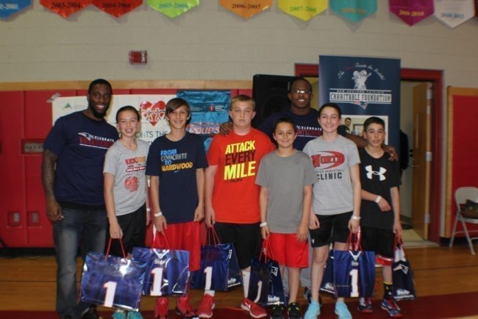 TWO NEW ENGLAND PATRIOTS players, cornerback Kyle Arrington, left, and wide receiver Matthew Slater, sixth from left, greet this year's top six fund-raising players from North Attleboro Middle School, which raised more than $95,000 in an American Heart Association fund raiser. / COURTESY PATRICIA HITCHCOCK