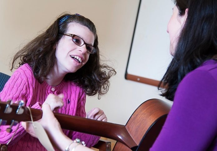 SWEET SOUNDS: Music therapist Nicole O’Malley works with client Maddie Manglass, a teenager who has been receiving music-therapy services for nearly 10 years. / PBN PHOTO/MICHAEL SALERNO