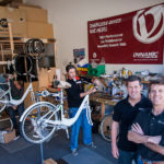 Firm sees future in chainless bikes BREAK CHAINS: Dynamic Bicycles Inc. makes shaft-drive systems that propel bicycles without a chain, potentially a major advantage for riders, such as tourists, not dressed in clothes designed for cycling. Pictured above, from left, are Dynamic employees Justin Plamondon and Jaime Raposa, with owners Devin Kelly and Perugini. / PBN FILE PHOTO/MICHAEL SALERNO