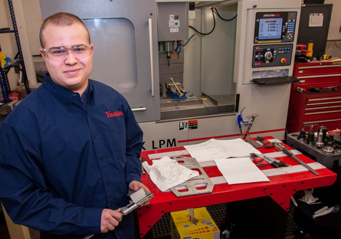 SKILLED LABOR: CNC machinist Dalton Fontaine, 19, of Swansea, a graduate of a vocational-tech high school in Massachusetts, is now working at Yushin making parts for robots. A new program will allow companies such as Yushin to find machinists trained in Rhode Island. / PBN PHOTO/MICHAEL SALERNO