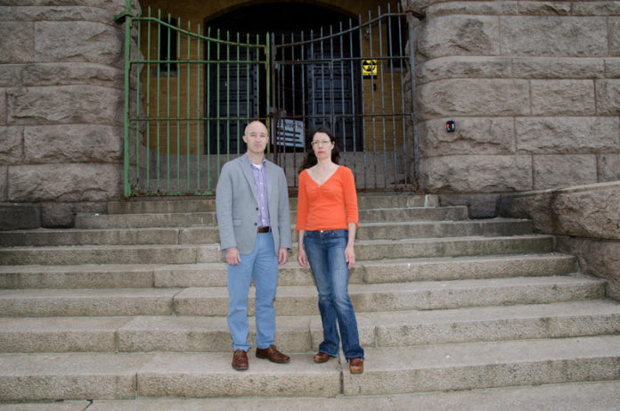 LANDMARK DECISION? Providence Preservation Society Executive Director  Brent Runyon and West Broadway Neighborhood Association Executive Director  Kari Lang in front of the Cranston Street Armory. The state recently scrapped plans for $3 million in renovations for the facility. / PBN PHOTO/JAIME LOWE