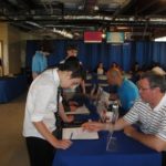 REVIEWING PART-TIME JOB OPTIONS with students at Vincent J. Gallagher Middle School, during the May 15 CU4 Reality Financial Education Fair, are Navigant Credit Union Vice President of Marketing Tim Draper and the credit union Marketing Manager Ross Silva.

 / COURTESY NAVIGANT