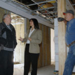 BUILDING SOMETHING: The Baltic Group Managing Partner Irene Schmitt surveys 400 Wesminster St. with Harold Antonson, grey jacket, city of Providence electrical inspector, and Don Hardy of Sheridan Electric. / PBN FILE PHOTO/BRIAN MCDONALD