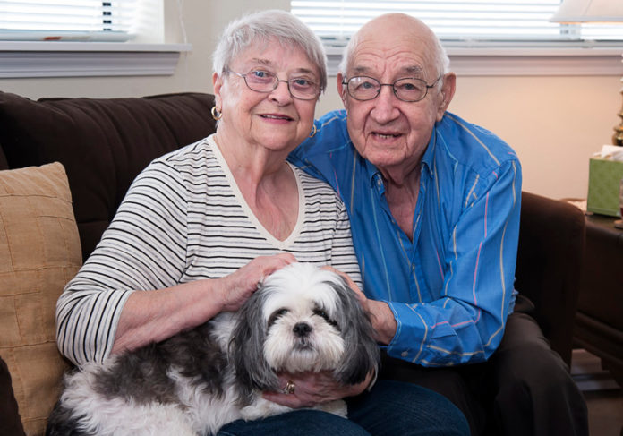 EXTENDED CARE: Pocasset Bay Retirement Community residents Marilyn and Richard Dutch with their 1-year-old Shitzu, Misty. The couple live in an independent-living apartment at Pocasset Bay. “Seniors still need someone to care for and their pets are like family,” said Karen Eller, administrator at Pocasset Bay. / PBN PHOTO/MICHAEL SALERNO