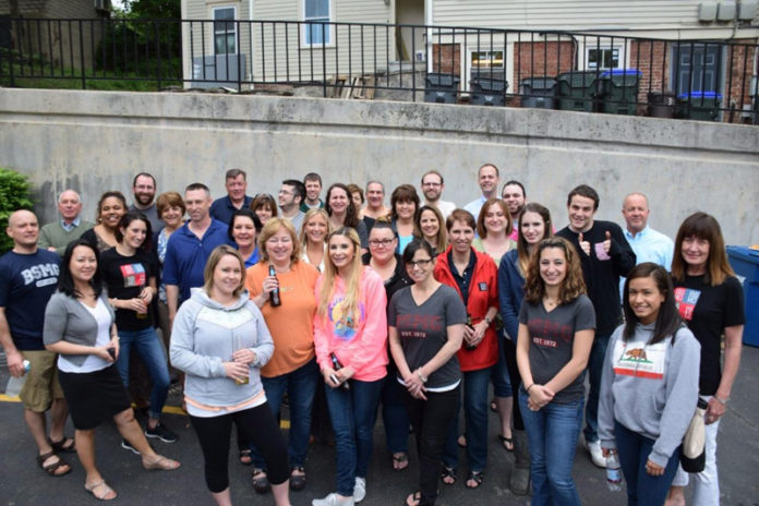 ALL TOGETHER NOW: Brokers’ Service Marketing Group employees take advantage of the company’s Memorial Day potluck picnic, one way that the firm helps build a cohesive team. / COURTESY BROKERS’ SERVICE MARKETING GROUP