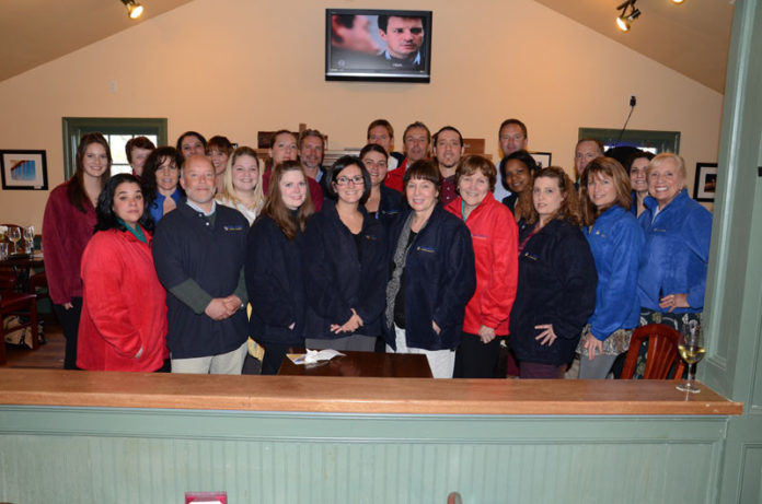 GROUP EFFORT: OceanPoint staff gathered last year for a celebration for a good first quarter, sporting fleece jackets handed out at the event. / COURTESY OCEANPOINT INSURANCE AGENCY