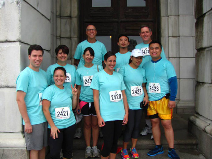 RACING AHEAD: Taking part in the CVS Caremark Downtown 5K demonstrates the team concept fostered at Sansiveri Kimball. / COURTESY SANSIVERI KIMBALL & CO.