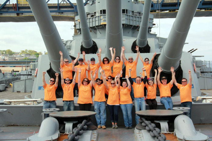 A CREW TO SERVE: Some of Embrace Home Loans’ staff performed their annual anniversary celebration service-day project on the USS Massachusetts in Fall River. / COURTESY EMBRACE HOME LOANS