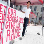 STOMACH PAINS: Renaissance Providence Hotel employee Santa Brito protests the denial of the $15 minimum wage for hotel workers during a Statehouse rally. / PBN PHOTO/MICHAEL SALERNO