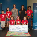 Mechanics Cooperative<br>
gives to Taunton YMCA NANCY STOKES, left, senior vice president of lending for Mechanics Cooperative Bank and a Taunton YMCA board member, joins Taunton YMCA Executive Director Stephanie Mancini to present a donation in the amount of $8,000 to local Taunton students who participate at the YMCA and directly benefit from the contribution. / COURTESY MECHANICS COOPERATIVE BANK