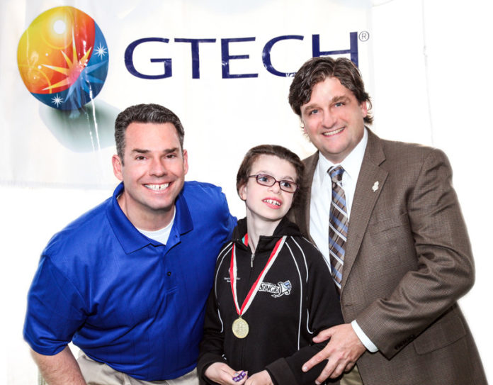 TIM RISHTON, left, GTECH chief accounting officer and Special Olympics Rhode Island board member, with athlete Maddie Manglass and Todd Manglass, Special Olympics Rhode Island chairman.