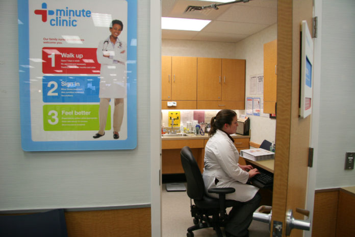 CVS CAREMARK CORP. and its MinuteClinic branch have affiliated with four health care providers in Connecticut, Texas, South Carolina and Louisiana to coordinate on clinical care and integrate electronic medical records. Above, nurse practitioner Corissa Pond enters patient data at a MinuteClinic in a Seekonk CVS/pharmacy. / PBN FILE PHOTO/MICHAEL PERSSON