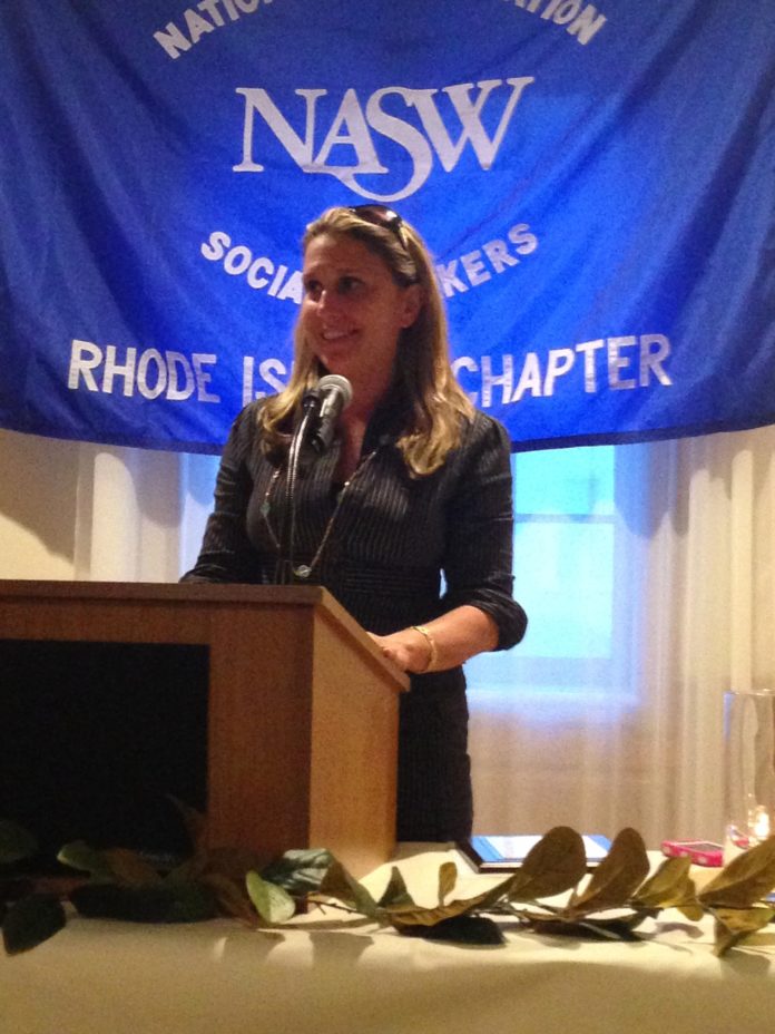 Leigh A. Reposa, manager of a Rhode Island youth suicide prevention program, accepts the 2014 Robert S. Burgess Community Service Award on June 25 at the Rhode Island Shriners-Imperial Room at One Rhodes Place in Cranston. / COURTESY CHRISTINE BANDONI
