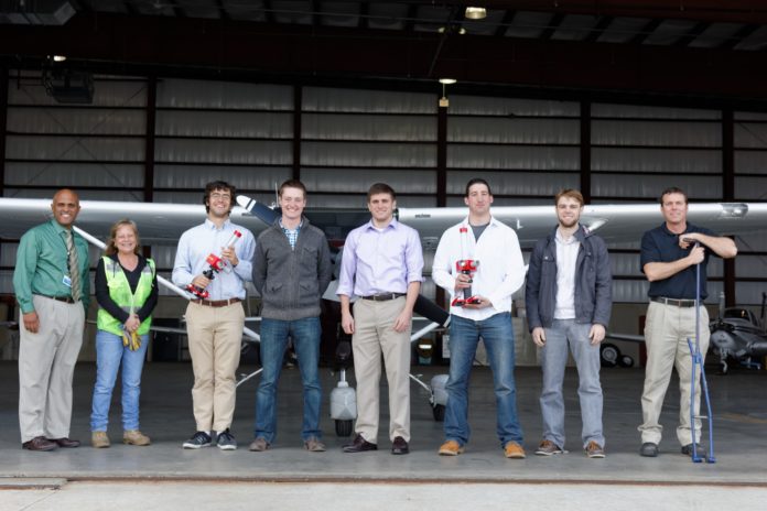 FROM LEFT: R.I. Airport Corporation Vice President Alan Andrade; AvPorts Line Service Technician Lynn Dadona; URI students David Powers, Ronald Wheeler, Lawrence Higgins, Kyle DellaGrotta and Christopher Clark; and AvPorts Operations Manager David Lucas at Quonset State Airport.