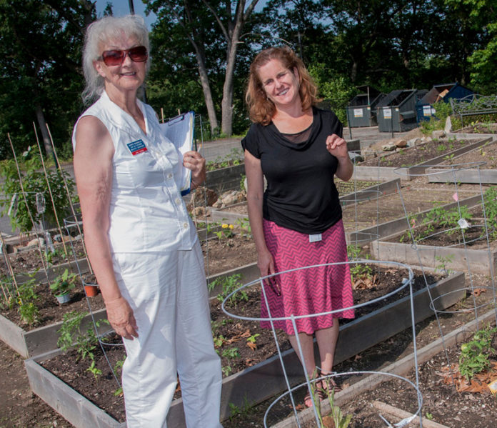 URI MASTER GARDENER Janice Marielle, left, and Eliza Sutton of Thundermist Health Center in the Thundermist community garden. / COURTESY MIKE SALERNO PHOTOGRAPHY