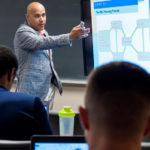URI business school still growing at 90 COURSE WORK: URI College of Business Administration doctoral student Gerry Matos teaches a class at the school’s Providence campus. The program is celebrating its 90th anniversary. / PBN PHOTO/ MICHAEL SALERNO