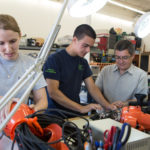 UMass Dartmouth to launch biz-plan contest IN CONTROL: Aquabotix Technology Corp. President and CEO Durval Tavares, right, with engineer Courtney LeBlanc and engineer intern Michael Montee at the company, which makes remotely operated vehicles for use underwater and under ice. / PBN PHOTO/RUPERT WHITELEY