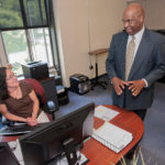 DEVELOPING STORY: Mark A. Stewart, the new state director of the R.I. Small Business Development Center at URI, speaks with executive assistant Patti Correia. / PBN PHOTO/ MICHAEL SALERNO