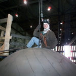 A RIGGER prepares to move a large component in the high bay shop at Electric Boat's Quonset submarine manufacturing facility. The company has added 720 new employees at its Quonset facility since the beginning of the year. / COURTESY ELECTRIC BOAT