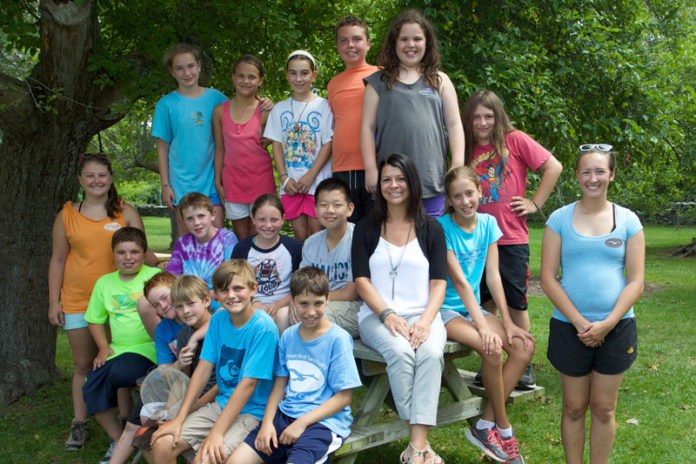 BANKNEWPORT Vice President and Middletown Branch Manager Linda Buchanan (seated center) recently joined fourth, fifth and sixth graders during the Norman Bird Sanctuary’s summer-camp explorers program.