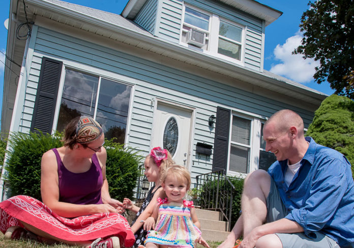 FINDING A PLACE: Previously renters in Providence, Scott and Heather Wade bought a home in Cranston and will benefit from a new tax credit for first-time homebuyers. They’re pictured above with daughters Sadie, center left, and Siduri. / PBN PHOTO/MICHAEL SALERNO