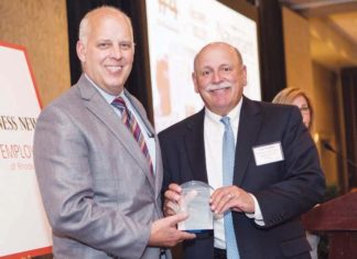 Roger Bergehein presents award to Navigant Credit Union CEO Gary Furtado  / Rupert Whiteley