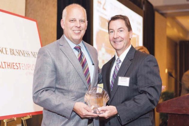 Tufts Health Plan’s Dean Bushy accepts the health care insurer’s award from Roger Bergenheim / Rupert Whiteley