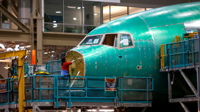 STRONG ORDERS FOR DURABLE GOODS, such as this Boeing 777 being built at the company's Everett, Wash., facility, helped the U.S. economy grow at a better than expected rate in the second quarter. / BLOOMBERG NEWS PHOTO/MIKE KANE
