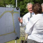 GOV. LINCOLN D. CHAFEE shows off the plans for the Apponaug Circulator Project at a groundbreaking ceremony.