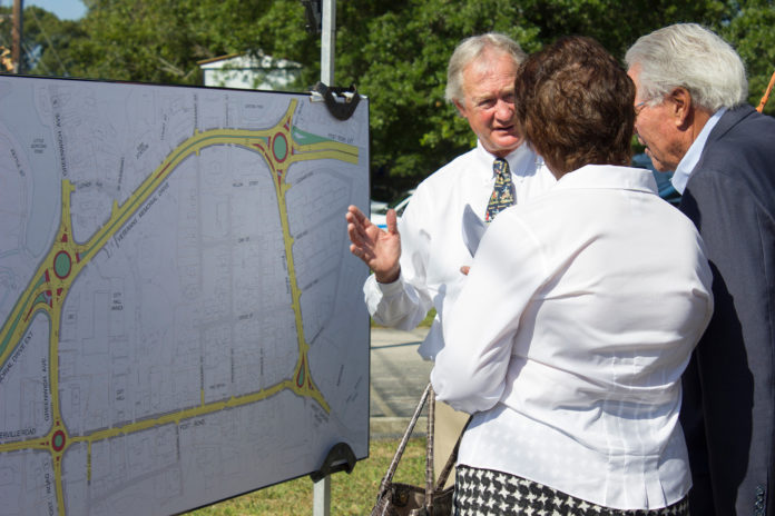 GOV. LINCOLN D. CHAFEE shows off the plans for the Apponaug Circulator Project at a groundbreaking ceremony.