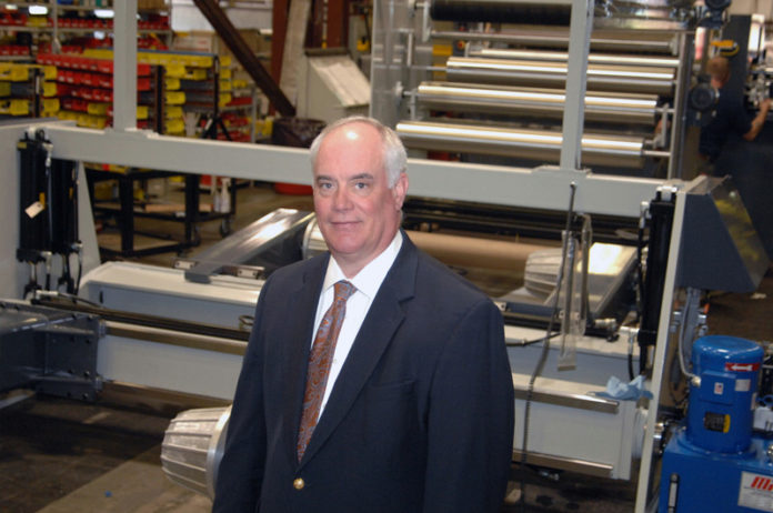 SHEET MUSIC: Joseph Matthews, president of Maxson Automatic Machine Co., says that the company is one of the last  independent sheeter manufacturers in the country. “It seems like every recession we lose another competitor,” he said. / PBN PHOTO/BRIAN MCDONALD