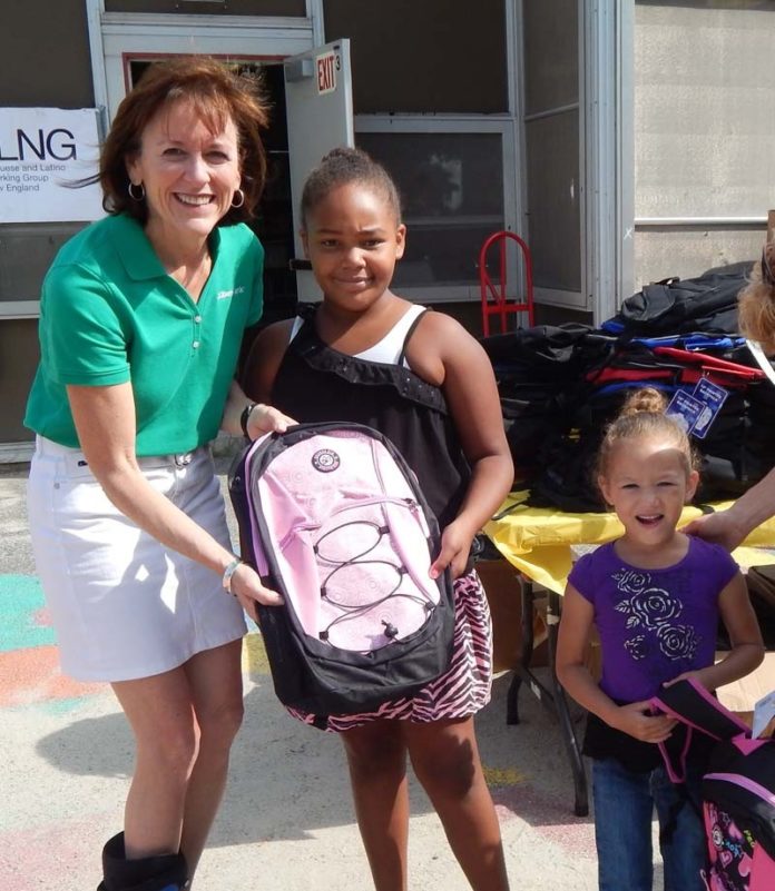 RBS CITIZENS FINANCIAL GROUP Head of Corporate Affairs Barbara Cottam, left, gives new backpacks filled with school supplies to sisters Xiomara Rosado and Kathaleena Rosado of Providence as part of the bank’s Gear for Grades program.