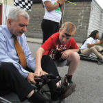 Center tailors teaching to kids as individuals OUTSIDE THE BOX: Serving mainly city kids from less-privileged neighborhoods, the Center for Dynamic Learning looks to help children who are not thriving in traditional classrooms. Above, U.S. Sen. Jack Reed takes instruction from Samuel Cunha, red shirt, and Krystalee Diaz Nieves prepares to start cart racing at the Center for Dynamic Learning’s End-of-Session Celebration at Culcutt Middle School in Central Falls. / PBN PHOTO/FRANK MULLIN