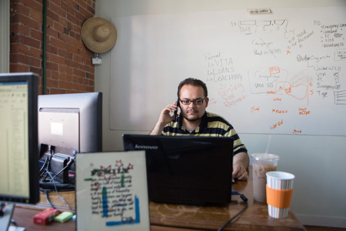 FUND RAISING: Frustrated with getting payday-loan controls passed in Rhode Island, some activists launched a nonprofit, Capital Good Fund. Pictured above is Capital Good Fund Loan Systems Manager Jose Fonseca. / PBN PHOTO/RUPERT WHITELEY