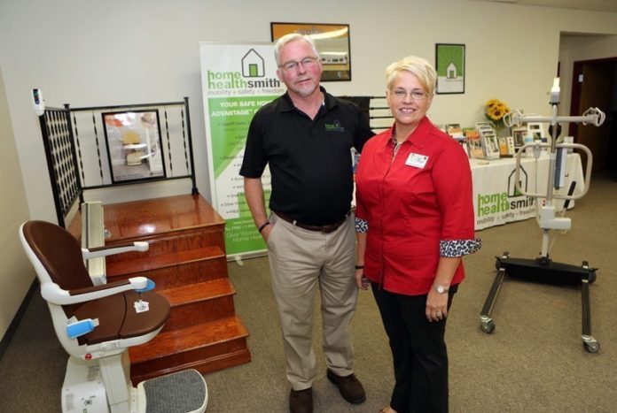 HOME AGAIN: Bill and Linda Bohmbach demonstrate a stair lift in the showroom at their Portsmouth company, Home Healthsmith. In two years the company, which provides adaptive mobility equipment, has grown from a home-based business to a 5,000-square-foot facility with five employees. / PBN FILE PHOTO/KATE WHITNEY LUCEY