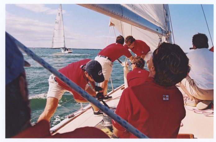 ALL ONBOARD: A corporate team on the American Eagle works together to trim the sails as it rounds a mark toward the finish line in a team-building race hosted by America’s Cup Charters in Newport. / COURTESY SMITHHILL