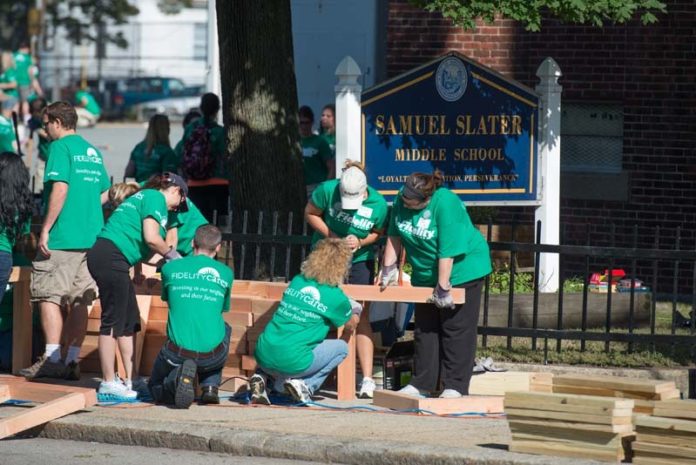 THE FIDELITY INVESTMENTS employee-volunteer team gets down to nuts and bolts during the volunteer event at Slater School in Pawtucket.