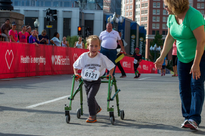 August Kletzien, a student at Vartan Gregorian Elementary School in Providence, pushes toward the finish line in the CVS Health Downtown 5K All Kids Can Inspirational Event. The run was one of 21 youth races offered at this year’s CVS Health Downtown 5K, held Sept. 21. The 25th annual charitable road-racing event attracted more than 7,000 people, including elite runners, walkers and children. / COURTESY SCOTT MASON PHOTOGRAPHY