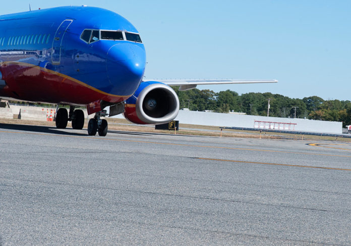TAKING OFF? A Southwest Airlines jet taxis in front of the airport’s newly constructed blast wall. / PBN PHOTO/ MICHAEL SALERNO