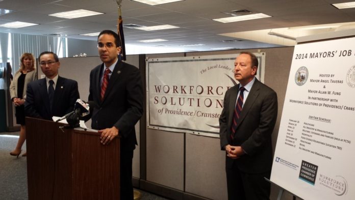 PROVIDENCE MAYOR Angel Taveras speaks at an event announcing the 2014 job fairs in this February file photo. He is flanked by Cranston Mayor Allan W. Fung, left, and Workforce Solutions Director Robert L. Ricci, right. At far left is Annette Lemieux, a counselor for Workforce Solutions. Workforce Solutions of Providence/Cranston also was involved with coordinating the job fairs.  / COURTESY CITY OF PROVIDENCE/JASON HERNANDEZ