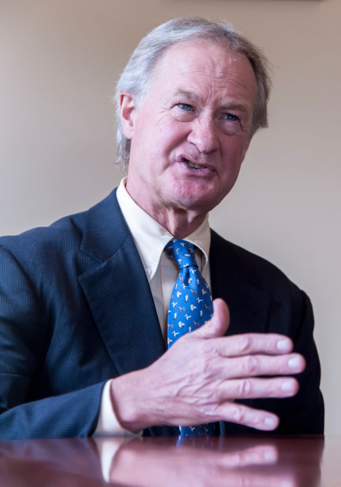 SENSE OF ACCOMPLISHMENT: Gov. Lincoln D. Chafee points to the Rocky Point Park deal as one of the hallmarks of his final year in office. / PBN PHOTO/ MICHAEL SALERNO