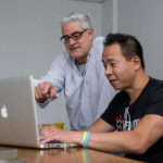 DIGITAL LITERACY: Alen Yen, president of iFactory Group, seated, with Dante Bellini, executive vice president at RDW Group. / PBN PHOTO/DAVID LEVESQUE
